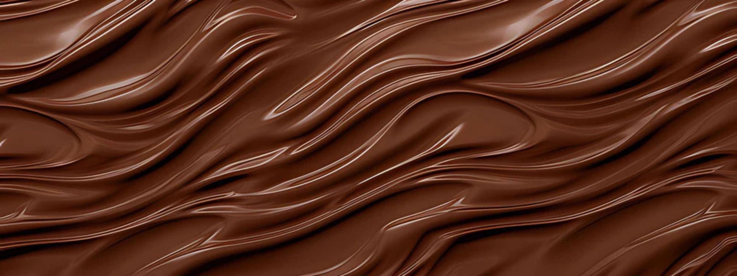 Assorted luxury chocolate bars and gift packs with ribbon and wine pairing on a rustic table