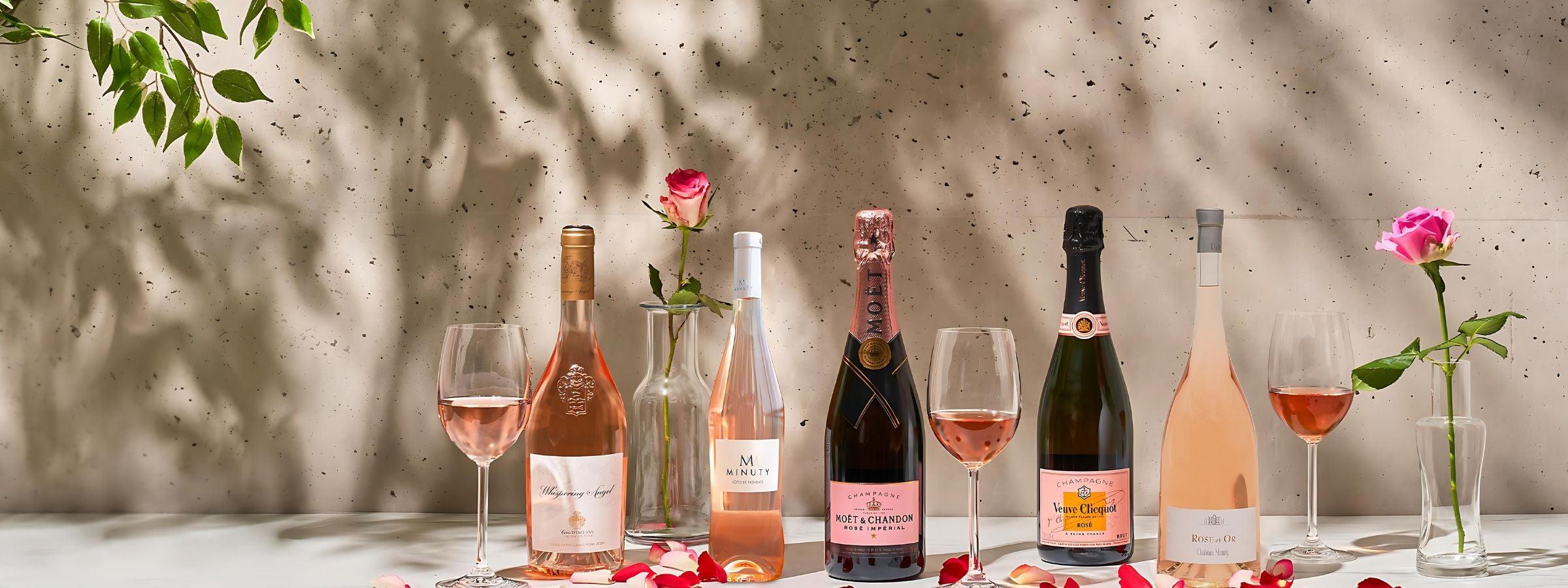 Bottles of Champagne and sparkling wine in ice buckets with glasses, strawberries and festive décor