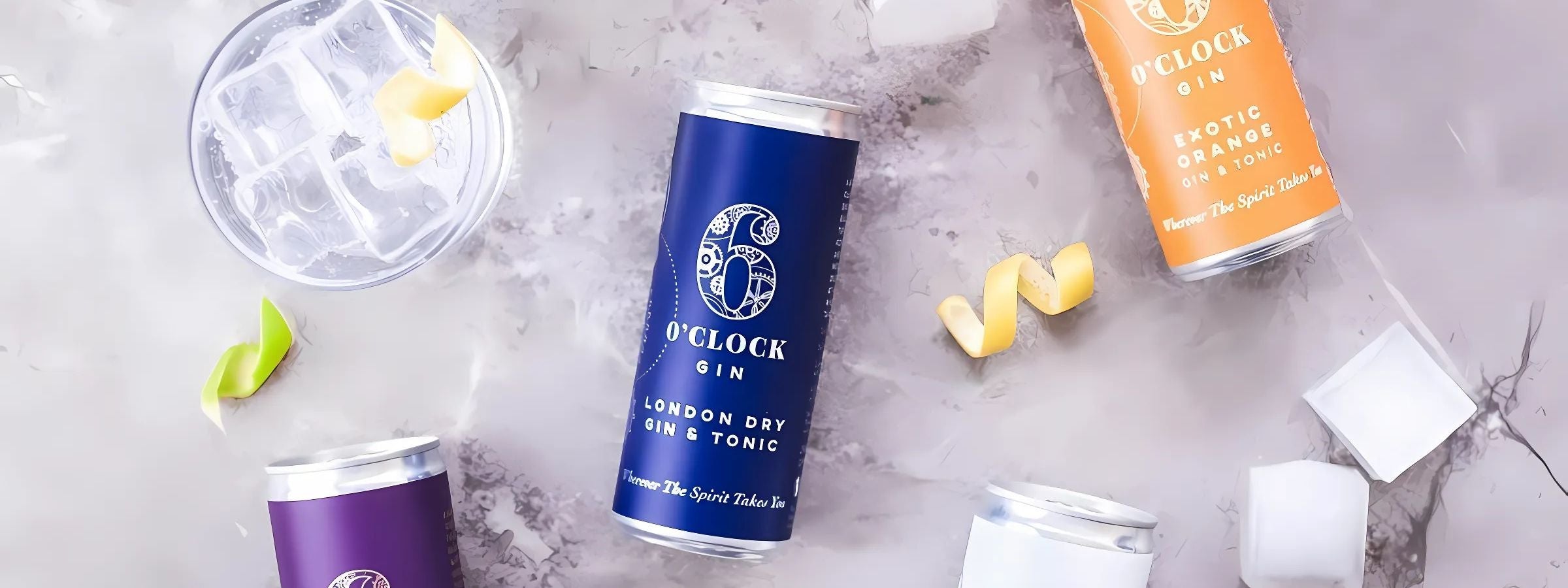 Assorted tonic waters, cocktail syrups, soda and mixers arranged with spirits and garnishes on a bar surface