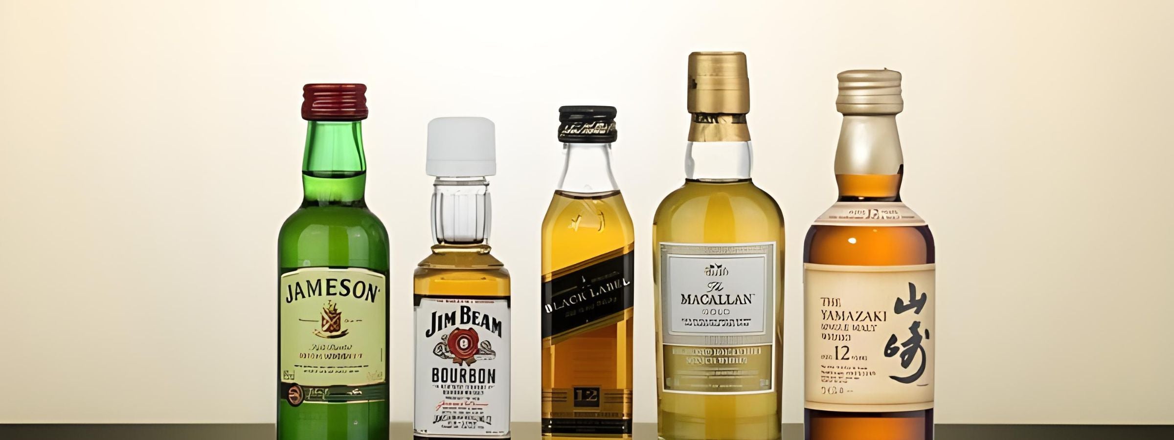 Miniature spirit bottles (vodka, whisky, gin, rum) arranged on gift tray or bar top