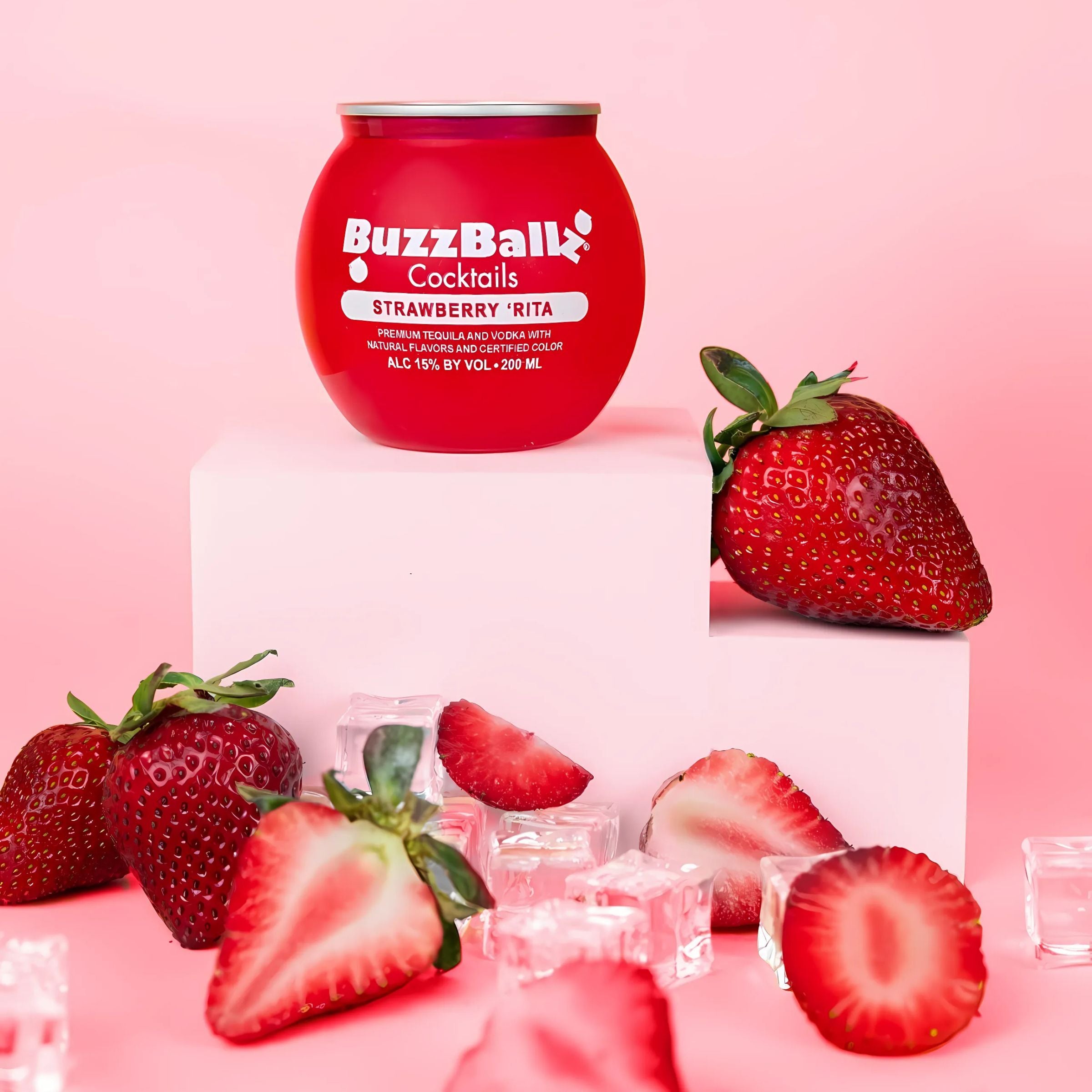 Red BuzzBallz container with strawberries and ice cubes on a pink background