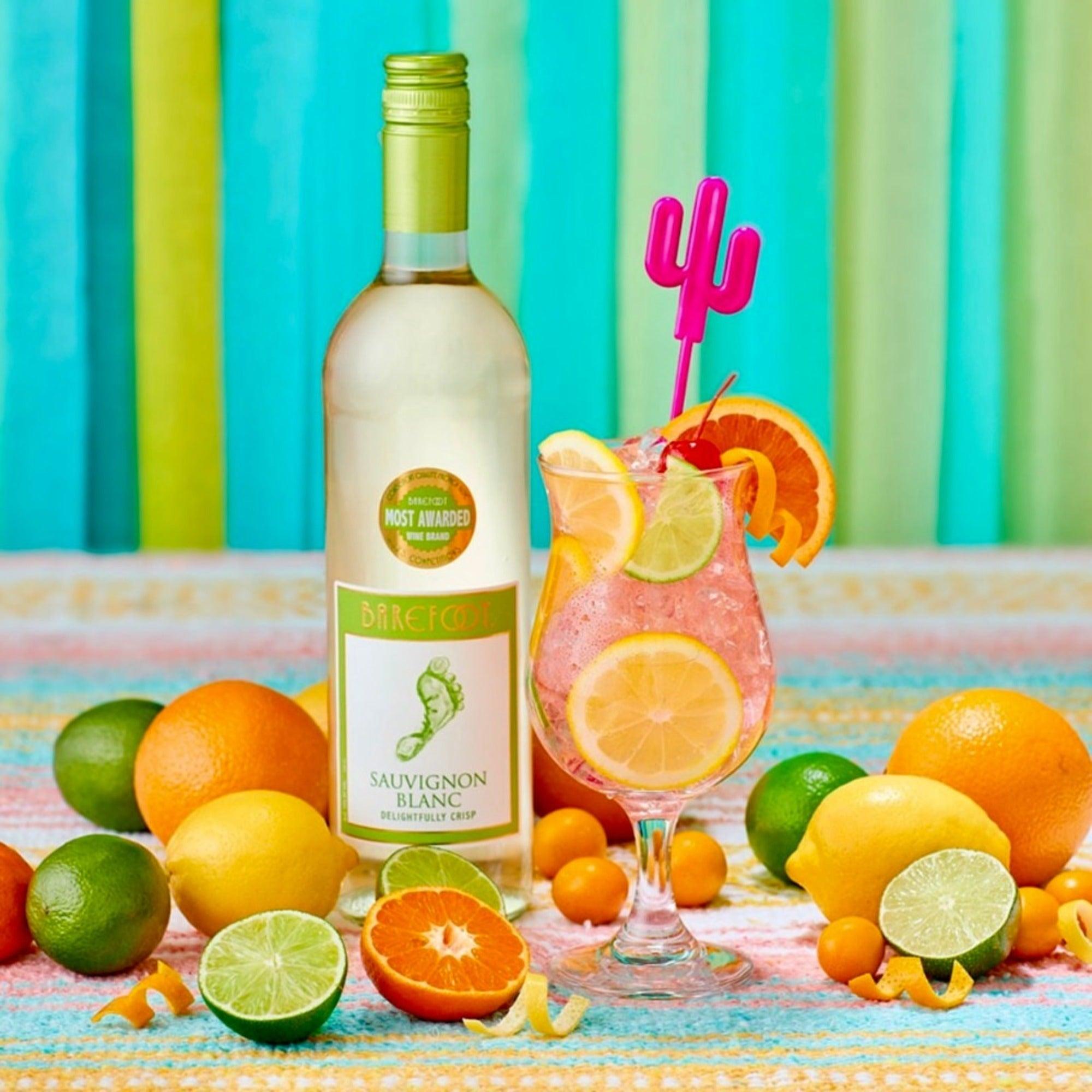 Barefoot Sauvignon Blanc 75cl bottle with citrus fruit and a chilled wine glass on a summer table