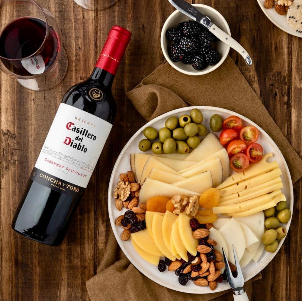 Casillero del Diablo Cabernet Sauvignon 75cl bottle with red wine glass, steak and roasted vegetables