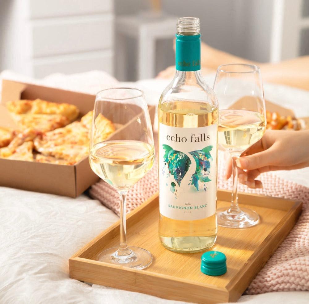 Echo Falls Sauvignon Blanc 75cl bottle with chilled glass and seafood plate on a sunny table