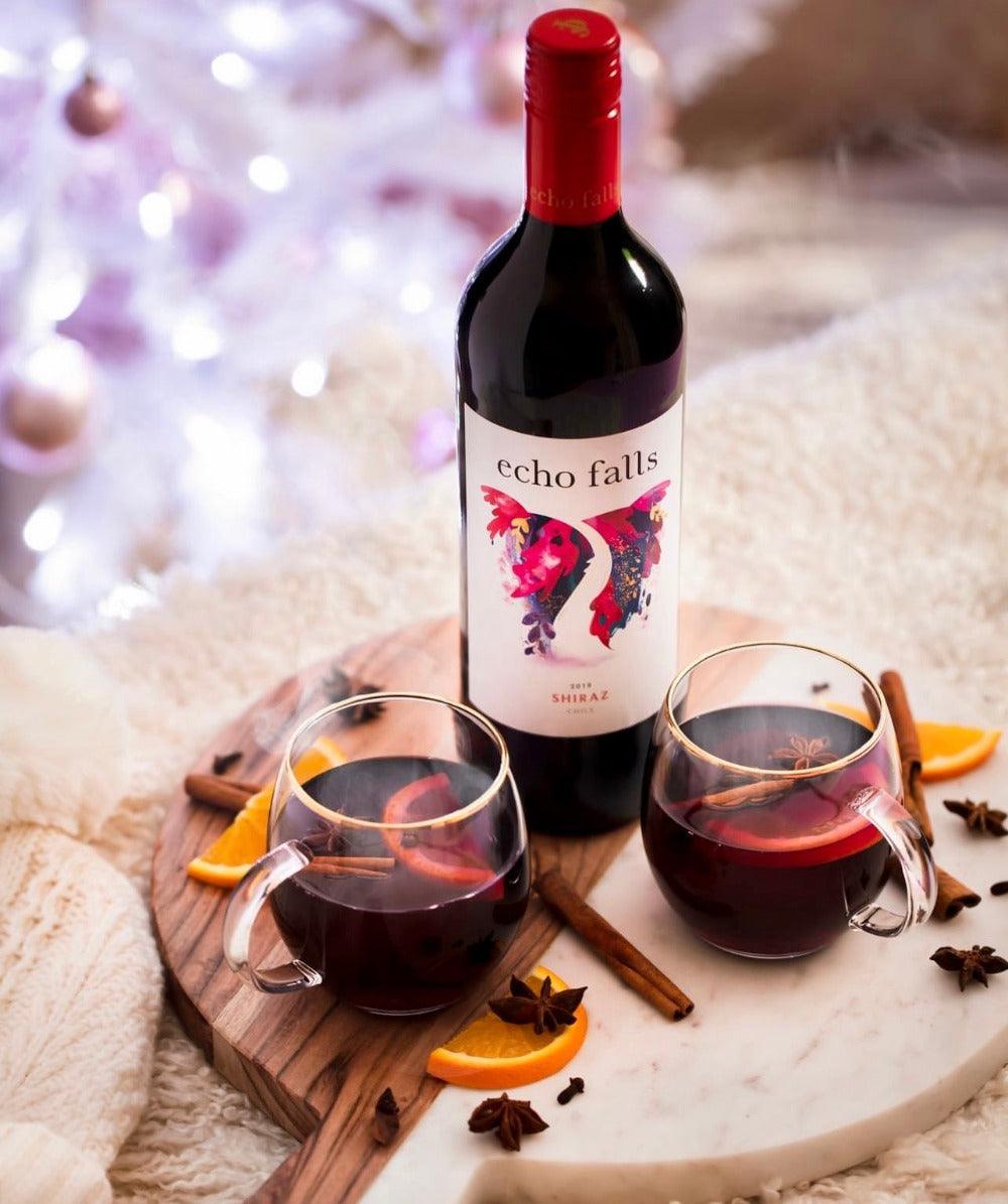 Echo Falls Shiraz 75cl bottle with red wine glass and dark fruit on rustic table
