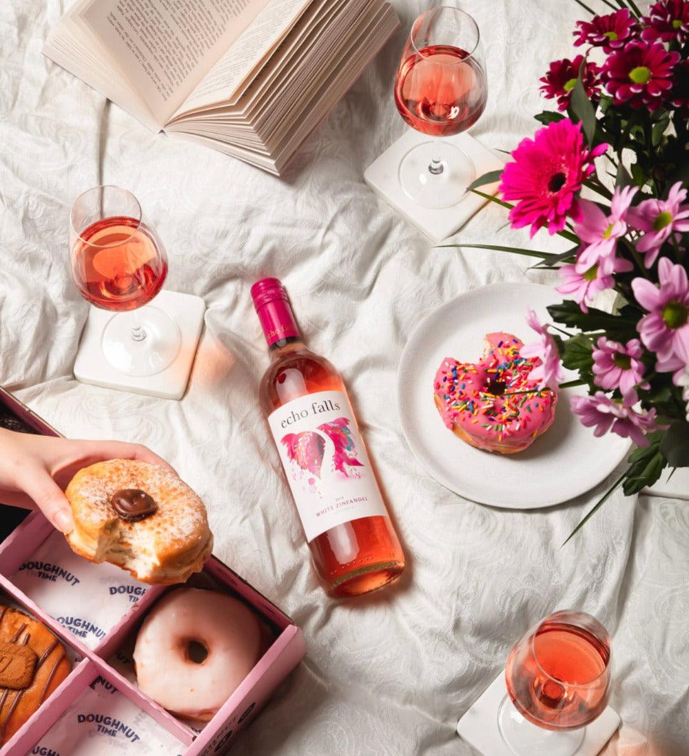 Echo Falls White Zinfandel 75cl bottle with strawberries and chilled wine glass on a summer table
