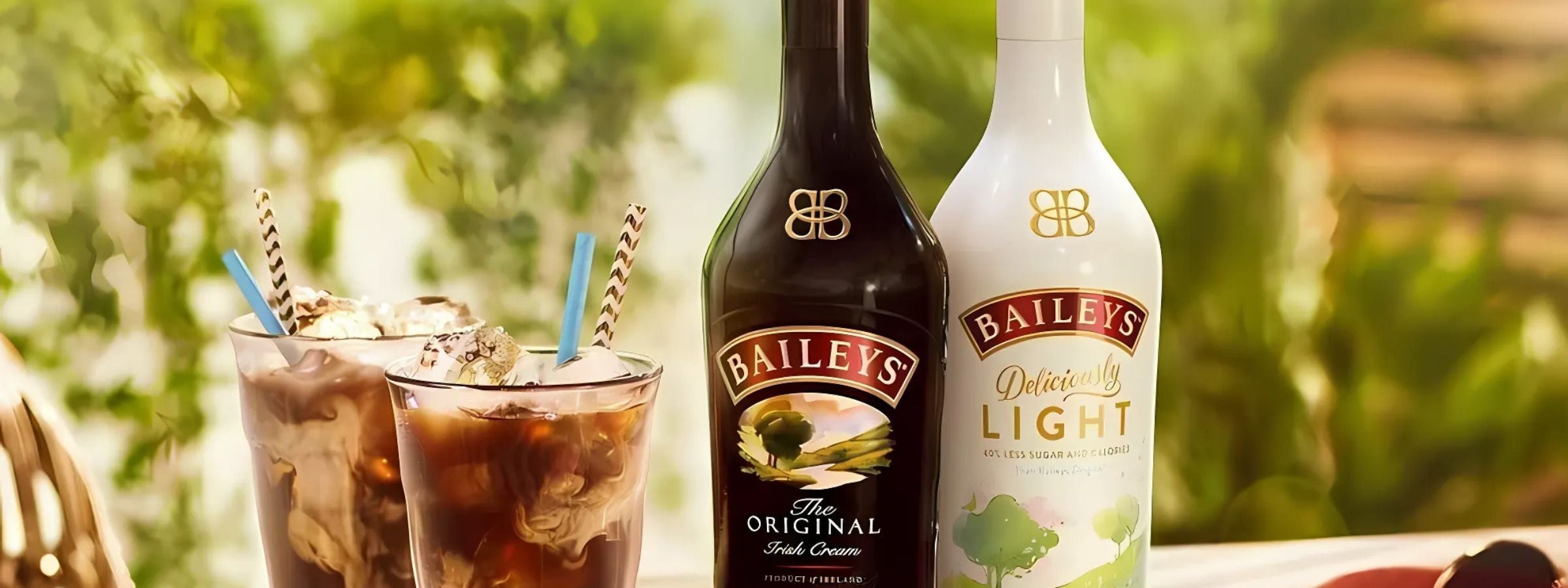 Baileys bottles in various flavours with coffee cups, dessert dishes, and gift boxes on a festive countertop