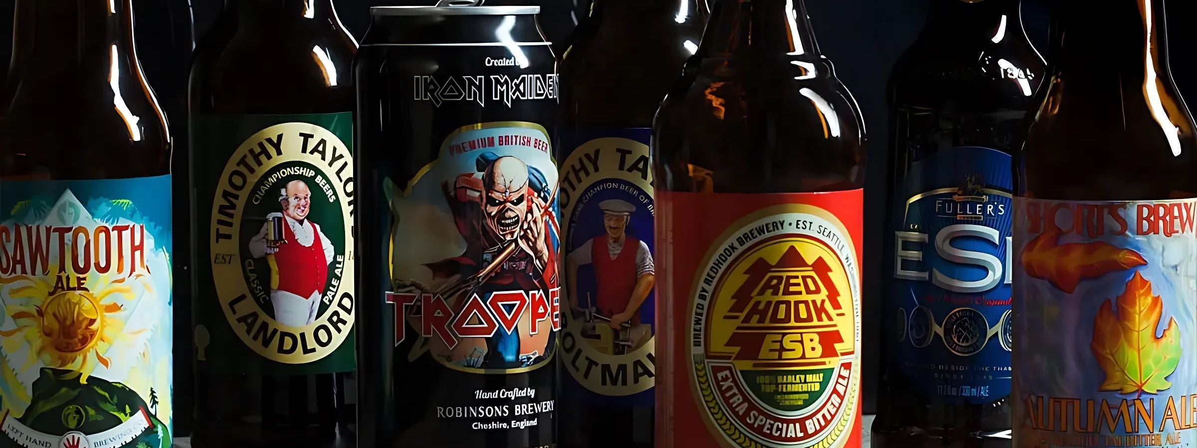 Bottles and cans of ale and bitter served with pub snacks and rustic glassware